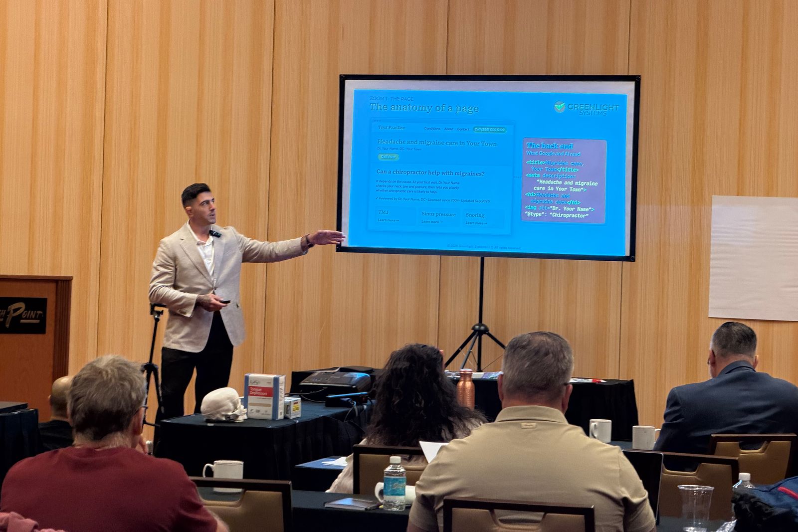 Jonathan Tomasian of Greenlight Systems pointing to a slide titled The anatomy of a page while doctors listen at the CFR Advanced Seminar in Las Vegas